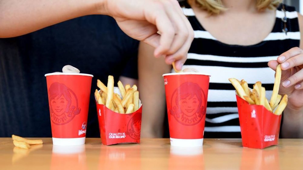 Man dipping fries in Wendy's Frosty