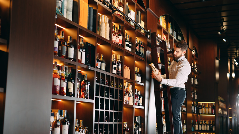 A sommelier checks out his wine selection. 