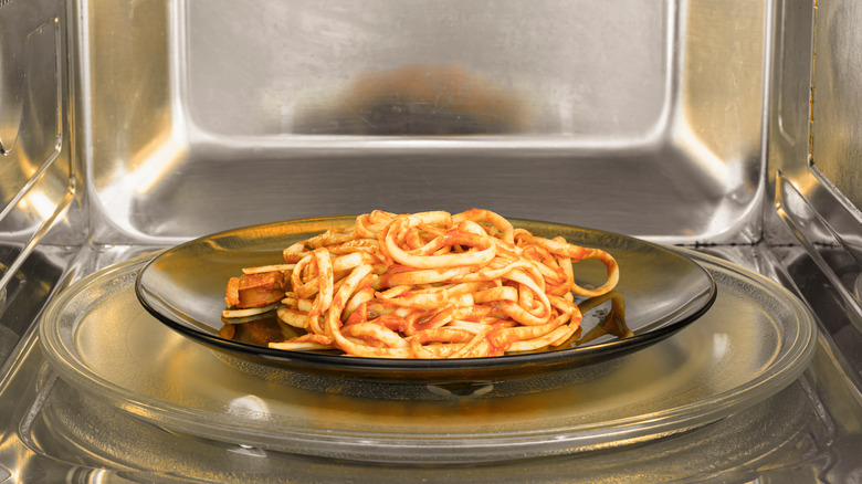 Plate of pasta in a microwave