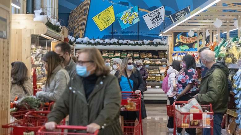 shoppers in a busy trader joe's store