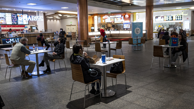 People eating in a mall food court