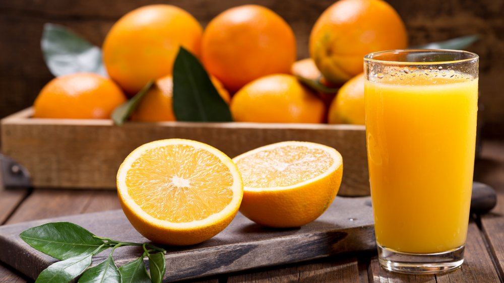 Orange juice with fruit in a crate