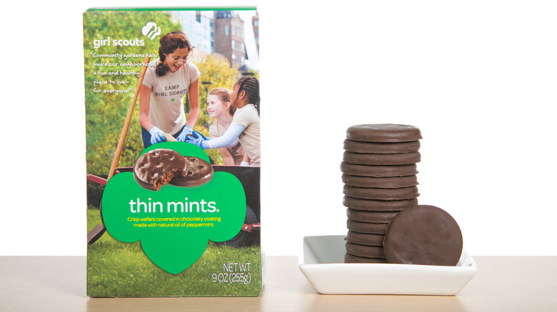 A box of Girl Scout Thin Mint cookies next to a white plate of cookies