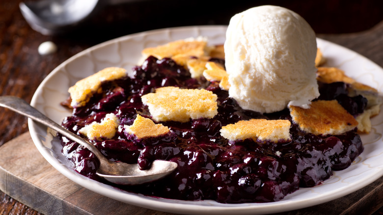 blueberry cobbler in dish with ice cream