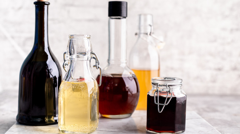 Different types of vinegar in glass bottles