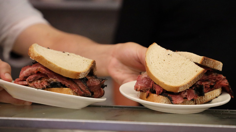 serving roast beef sandwiches on rye bread