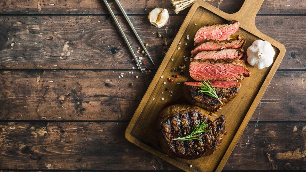 A cooked filet mignon on a cutting board