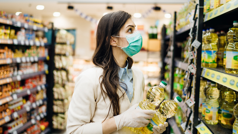 Person shopping for oil in store