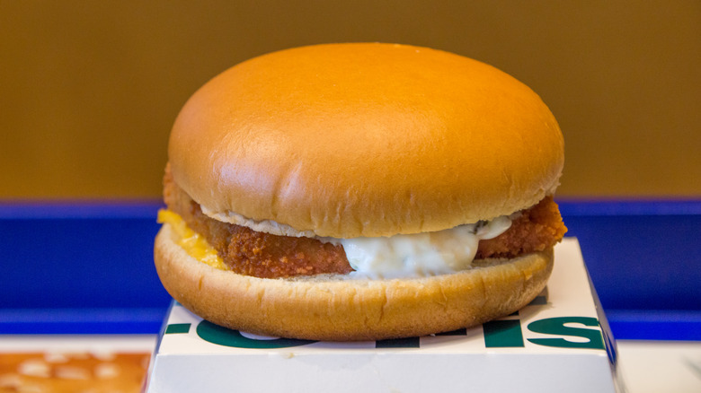 Filet-O-Fish sandwich with tartar sauce on top of a white box