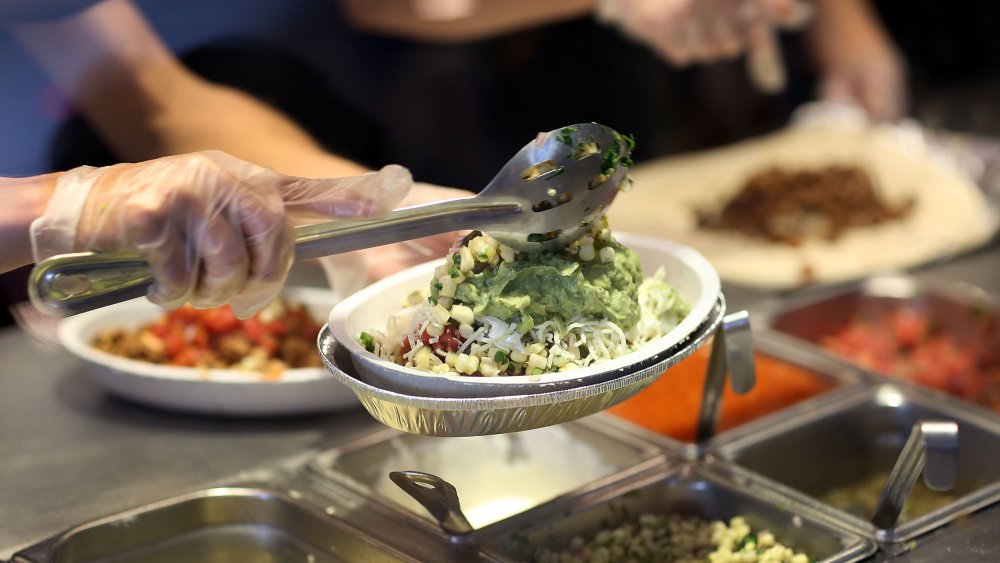 Chipotle burrito bowl being scooped by employee