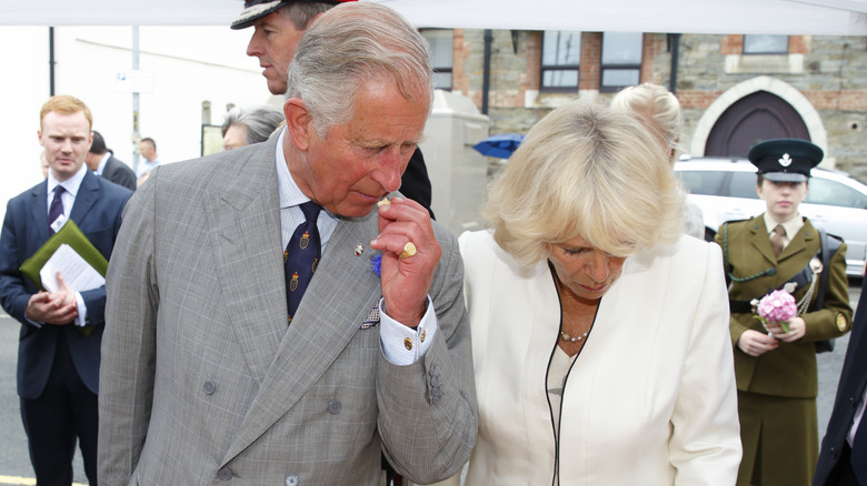 King Charles sampling cheese with wife