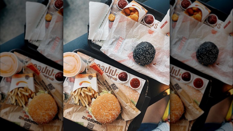 Burger King burgers, fries and drinks on trays