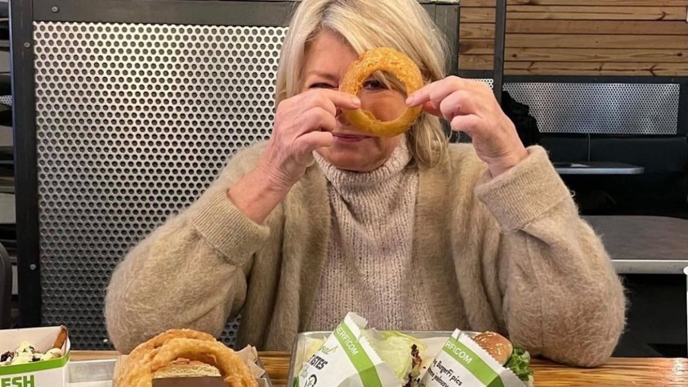 Martha Stewart holding BurgerFi onion ring