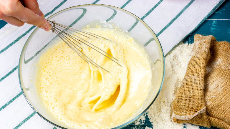 Stirring waffle batter in bowl