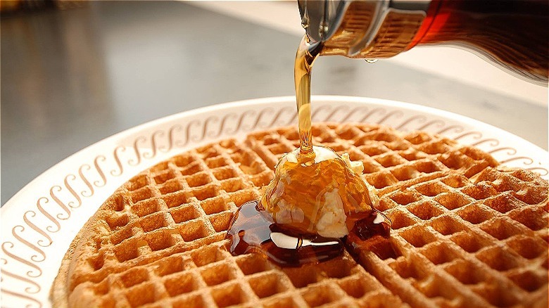 Maple syrup poured on waffle