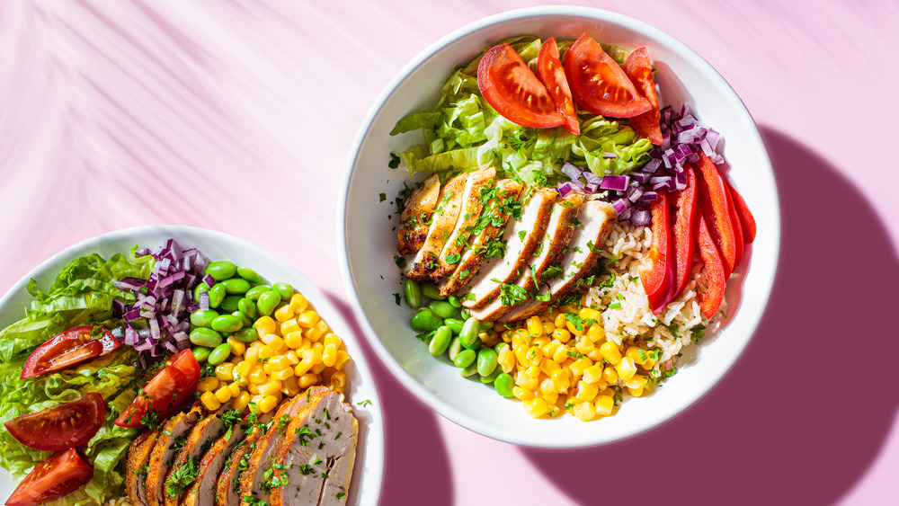 bowls with rice, chicken, vegetables