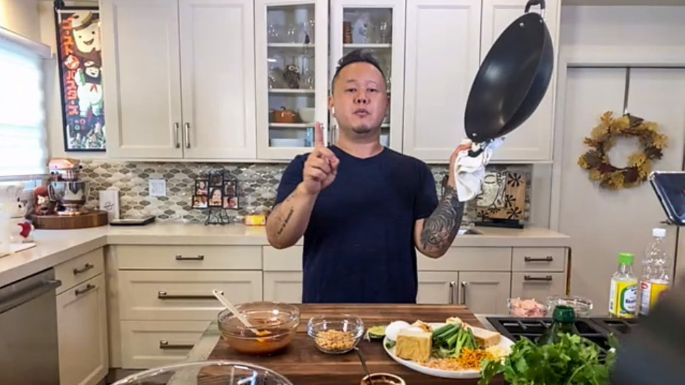 Jet Tila cooking in kitchen