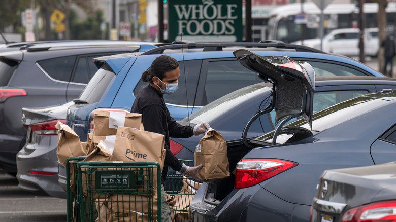 Person loading groceries into car