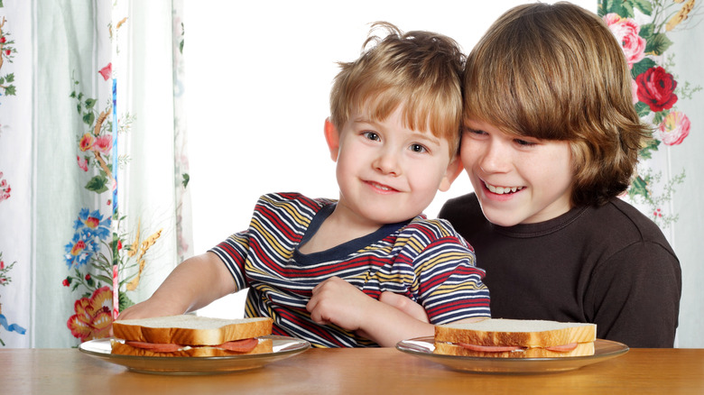 Children eating bologna sandwiches