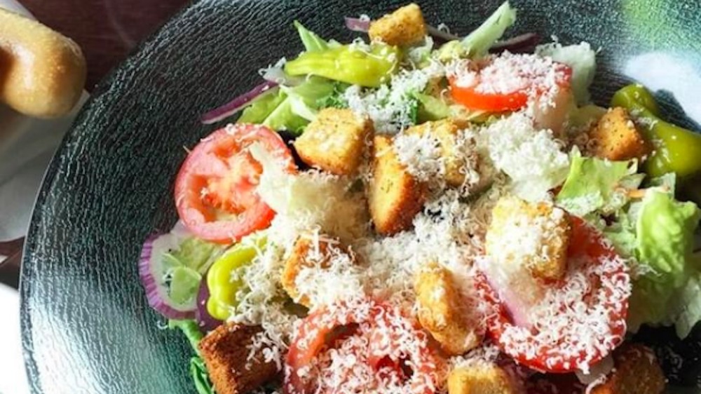 Bowl of Olive Garden house salad topped with cheese