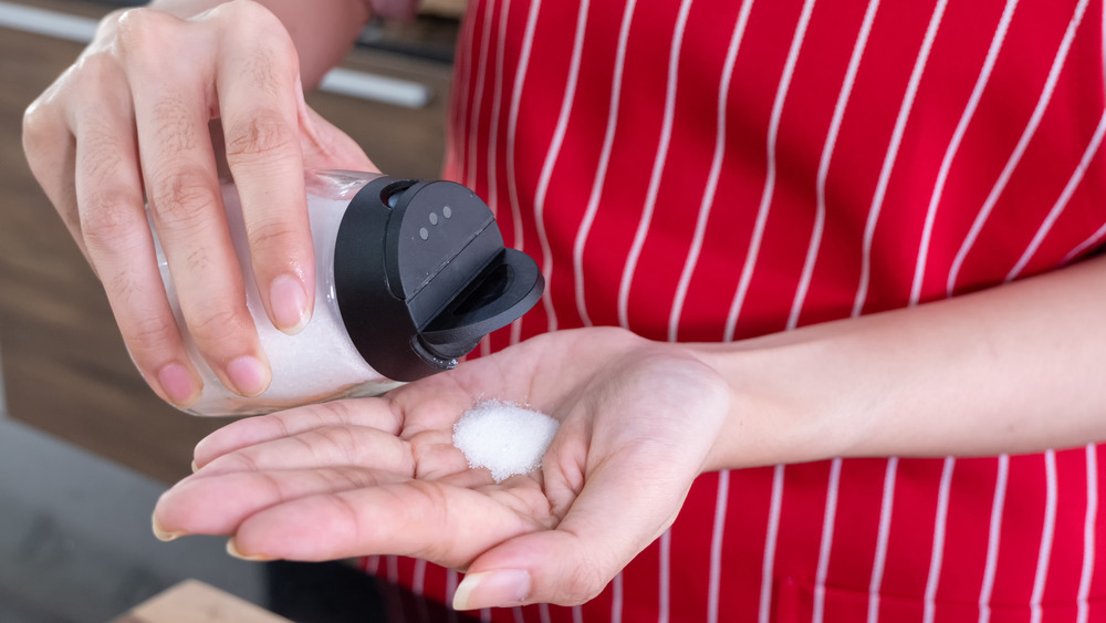 Cook holding a salt shaker