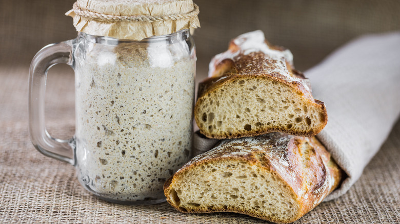 sourdough bread with a jar of starter