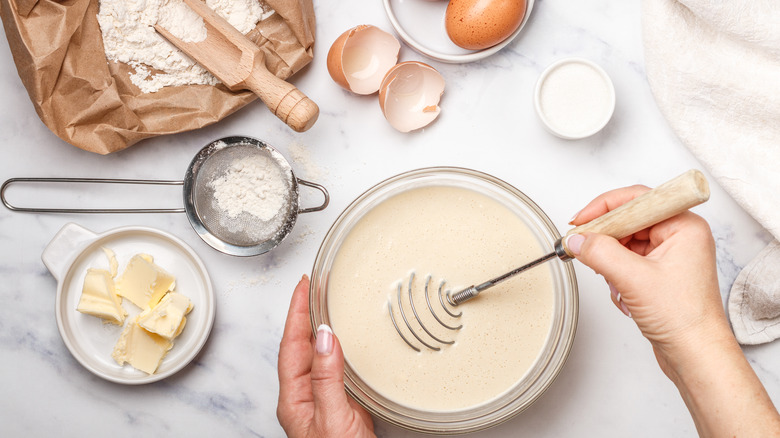 Woman whisking batter with eggs, flour, and butter