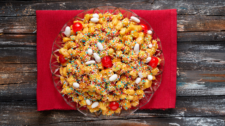 A plate of struffoli on a red napkin