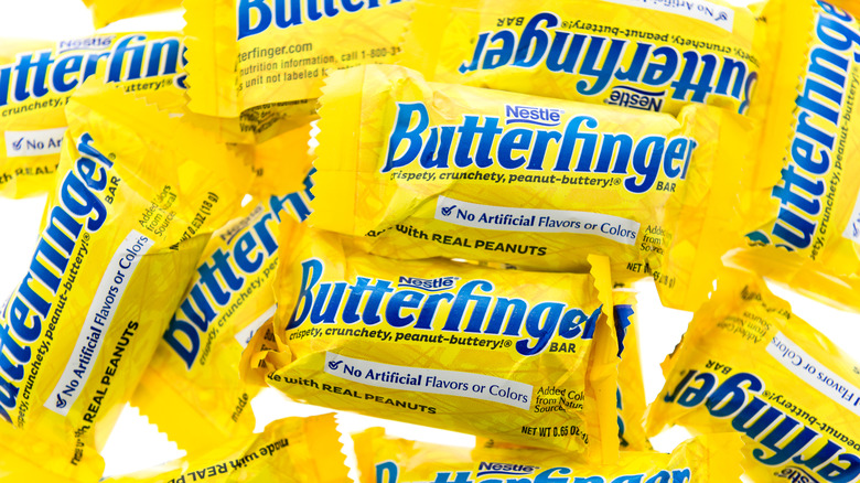 A pile of Butterfinger bars covered in the classic yellow label.