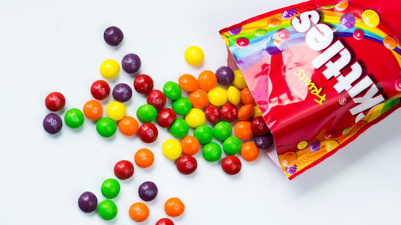 A bag of skittles spilling out candy