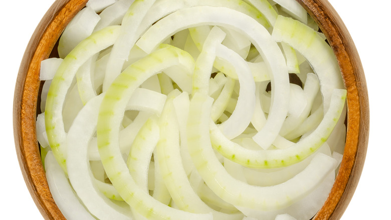 White onion sliced crosswise in a bowl