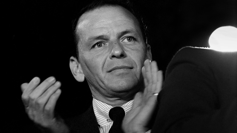 Black and white photo of Frank Sinatra clapping hands