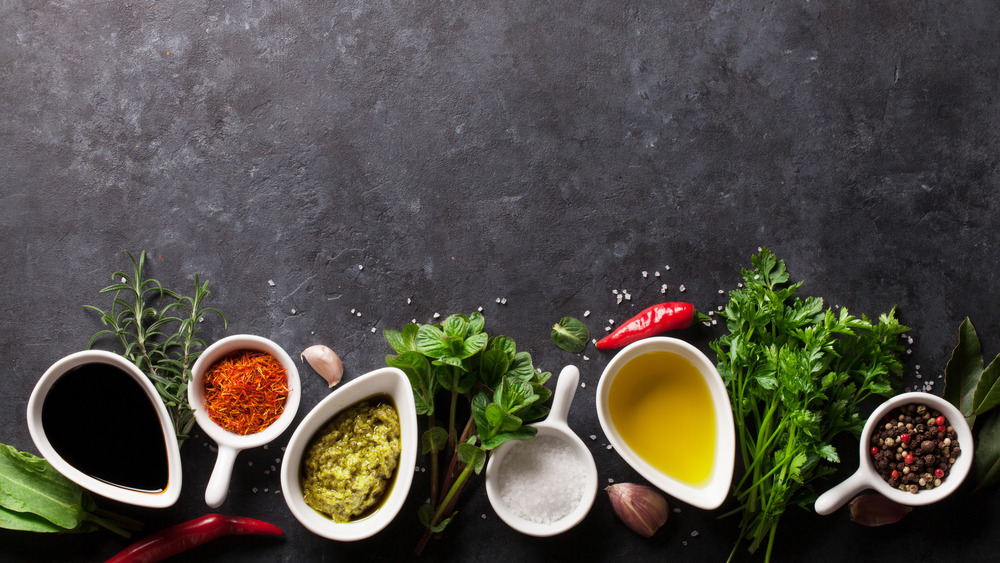 Various types of spices and seasonings on dark background