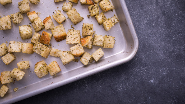 Bread cubes on baking sheet