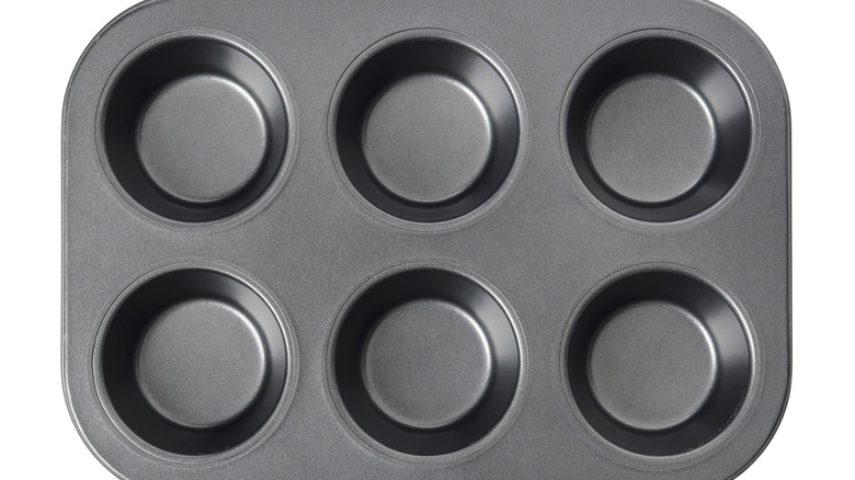 Muffin tin pan on white background