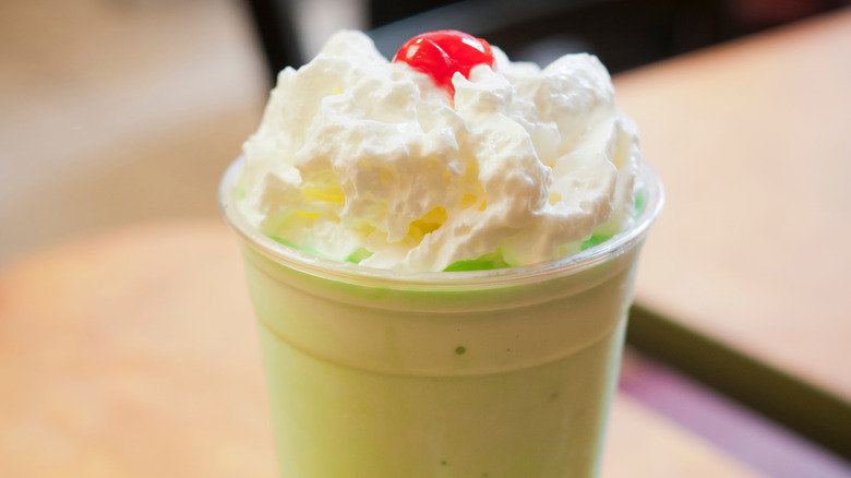 mcdonald's shamrock shake on table with whipped cream