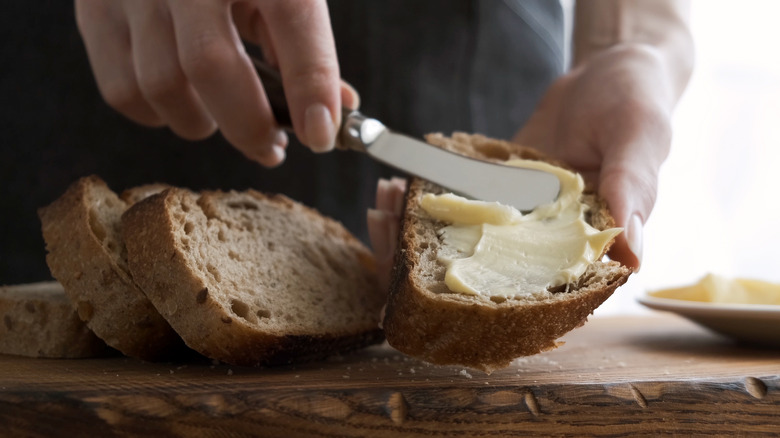 Buttering a piece of bread