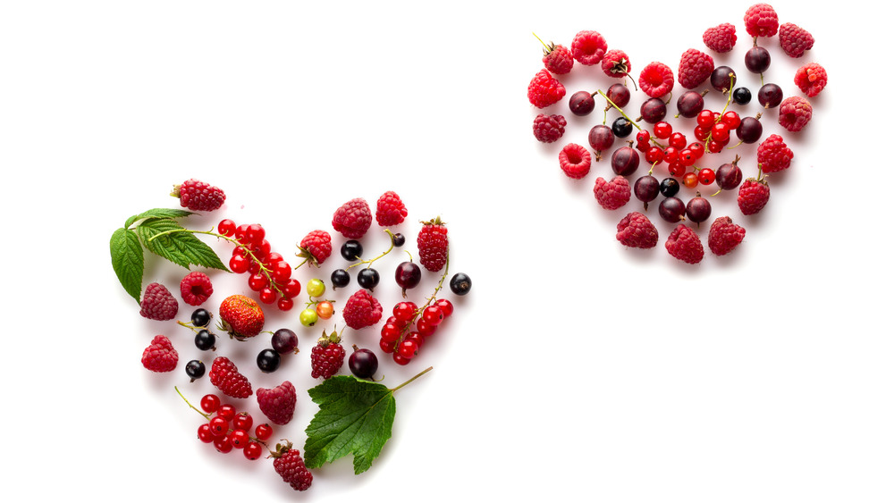 Red heart in center of fruits and vegetables