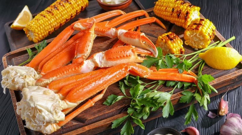 crab legs on wooden tray with corn