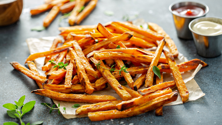 Pile of french fries with ketchup and mayo