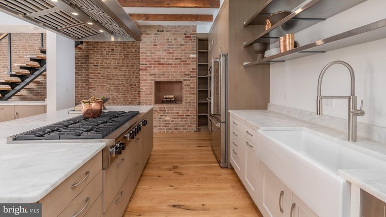 Renovated kitchen with brick wall