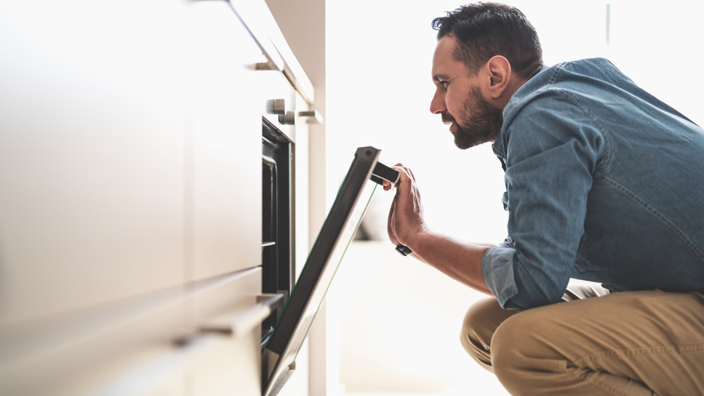 Man opening oven