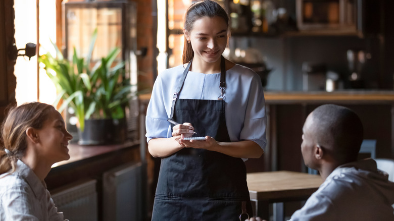 Server taking couples' order