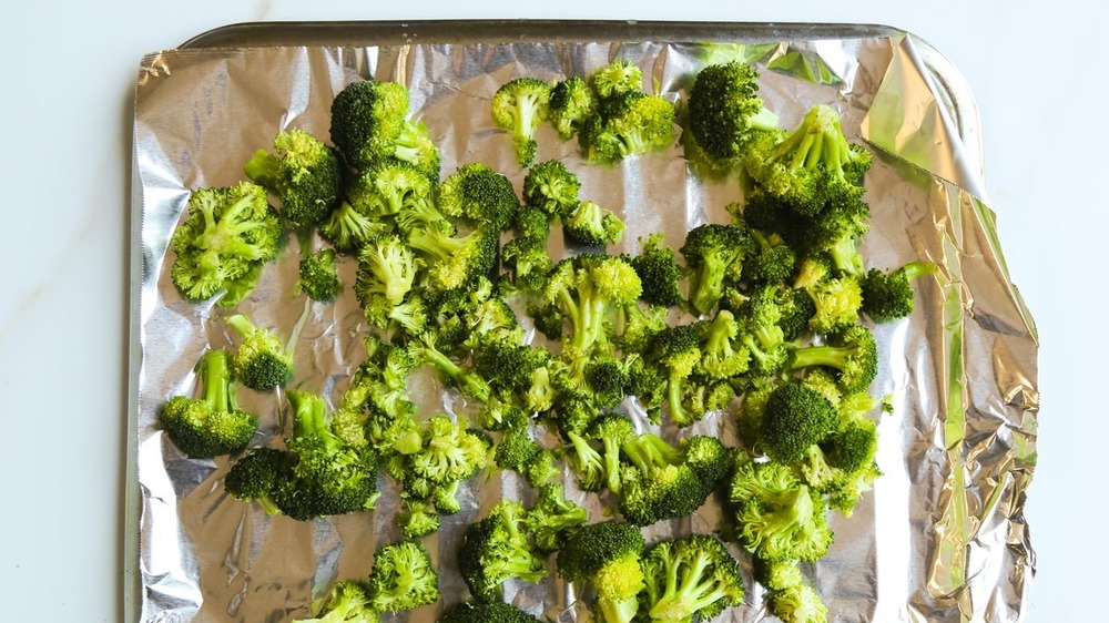 roasted broccoli laying on pan