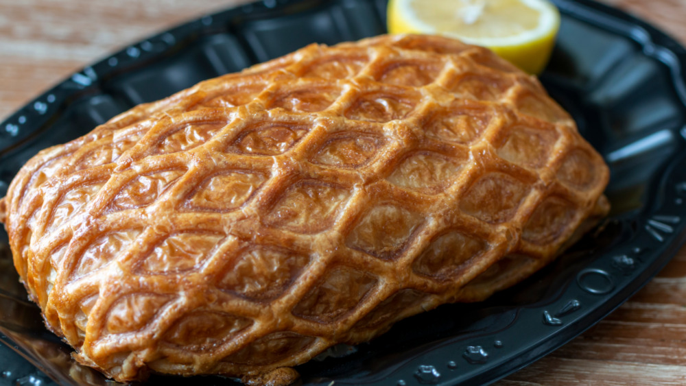 Salmon coulibiac on a black plate