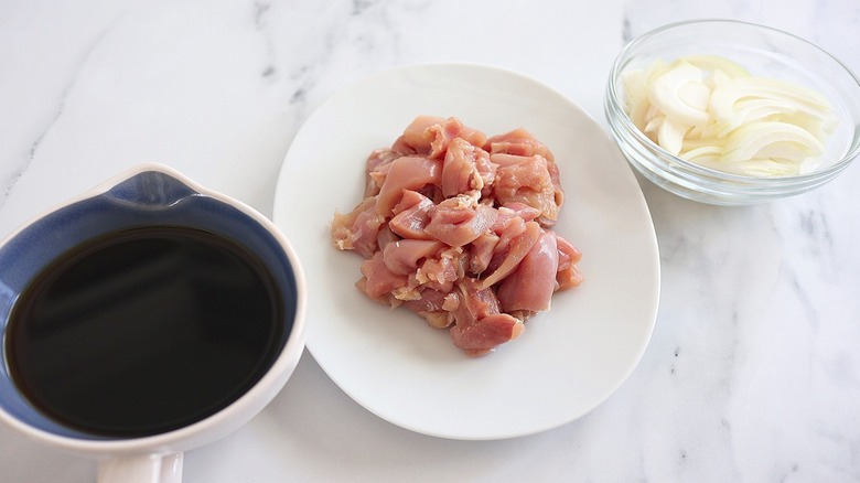 Soy sauce mixture with chopped chicken and onions