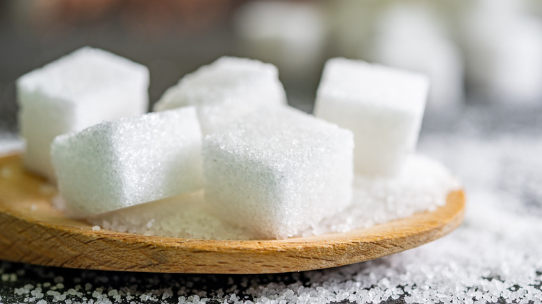 Sugar cubes on wooden plate