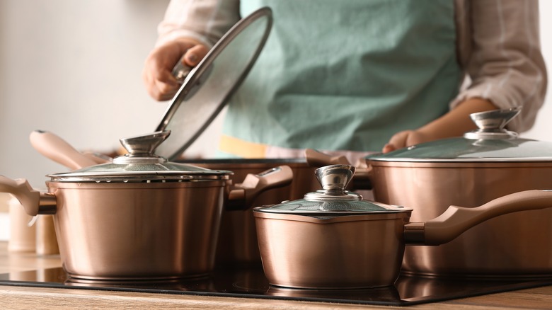 Person cooking with pots