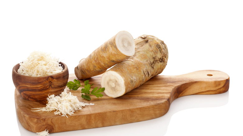 Grated horseradish next to raw horseradish