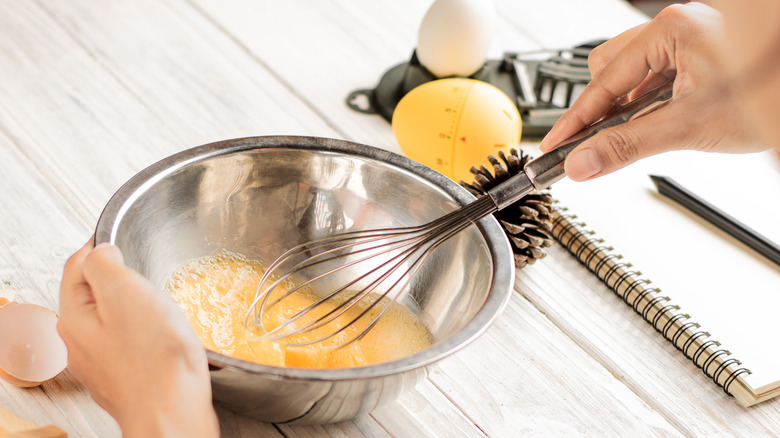 Person whisking eggs